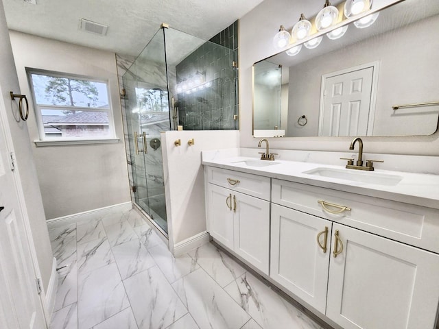 bathroom featuring an enclosed shower and vanity