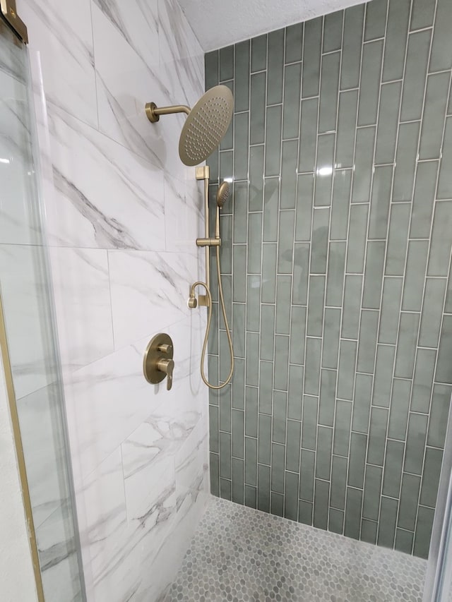 bathroom with a tile shower