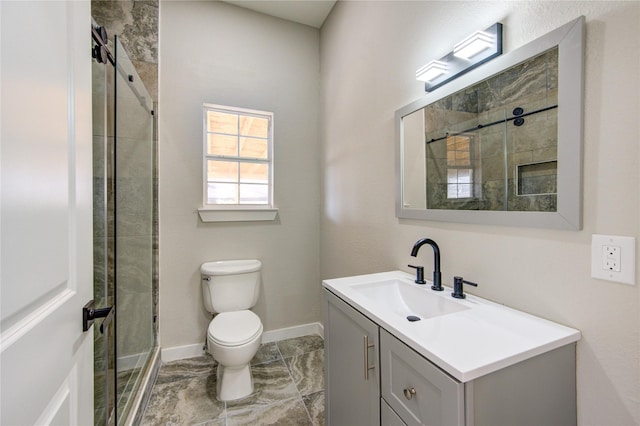 bathroom featuring vanity, toilet, and a shower with shower door