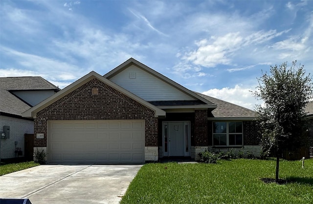 view of front of property featuring a garage and a front lawn