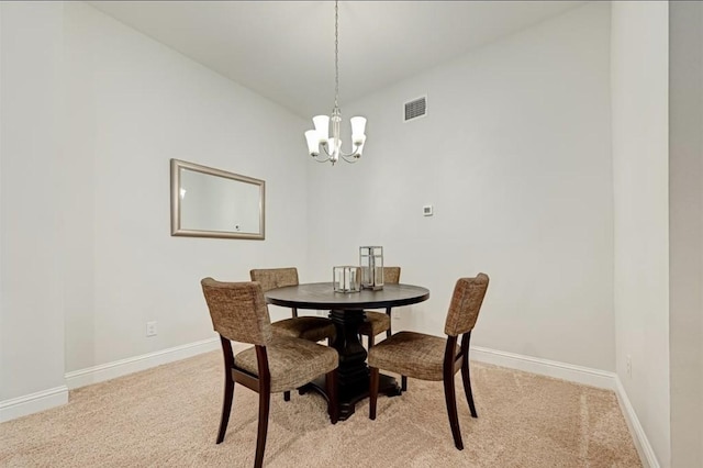 carpeted dining room with lofted ceiling and a chandelier