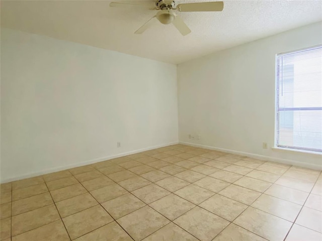 spare room featuring light tile patterned flooring and ceiling fan