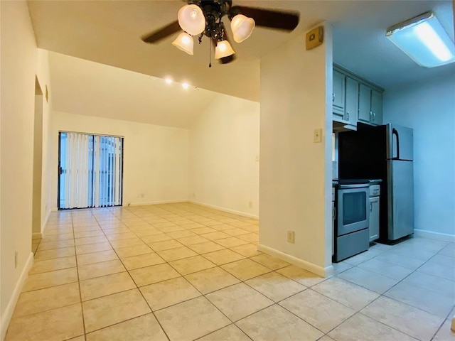 kitchen featuring light tile patterned flooring, stainless steel refrigerator, ceiling fan, and range