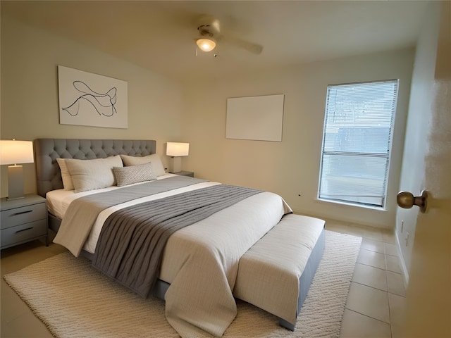 tiled bedroom featuring ceiling fan