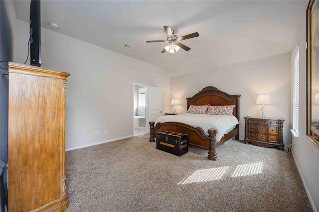 carpeted bedroom with ceiling fan, ensuite bathroom, and vaulted ceiling