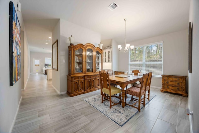 dining space with a chandelier