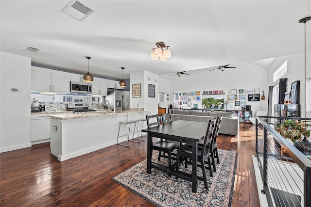 dining area with dark hardwood / wood-style flooring and ceiling fan