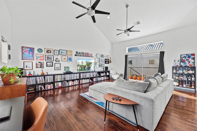 living room with ceiling fan, dark hardwood / wood-style flooring, and high vaulted ceiling