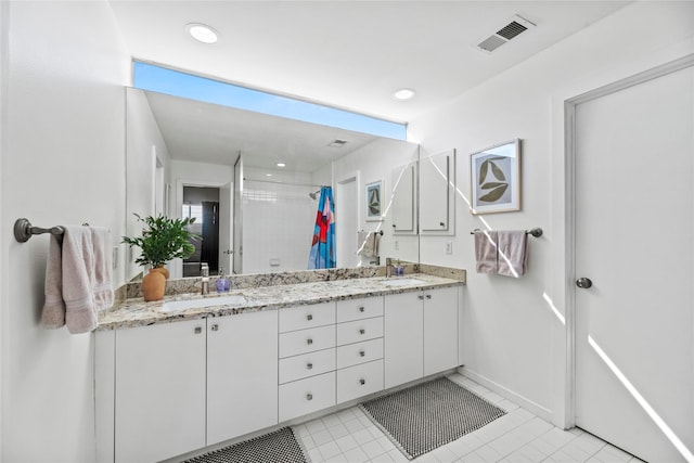 bathroom with tile patterned flooring, vanity, and curtained shower