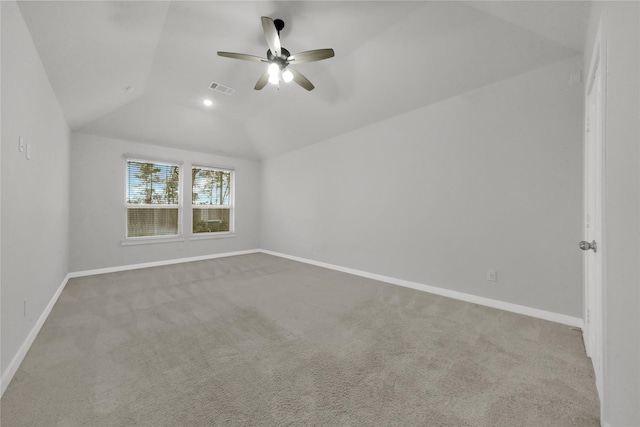 carpeted spare room with vaulted ceiling and ceiling fan