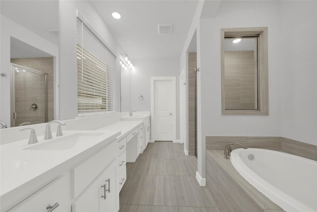 bathroom featuring separate shower and tub and vanity