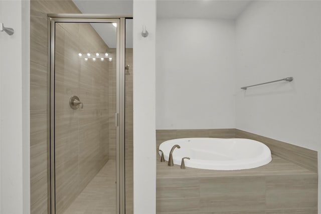 bathroom with separate shower and tub