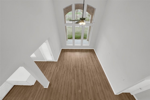 unfurnished living room featuring ceiling fan and wood-type flooring