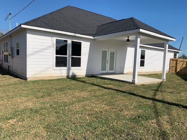 back of house with a lawn, ceiling fan, french doors, and a patio