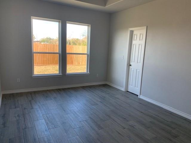 unfurnished room with dark wood-type flooring