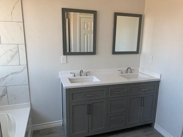 bathroom featuring vanity and a washtub