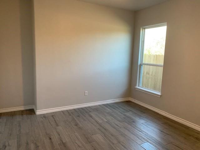 unfurnished room with hardwood / wood-style floors