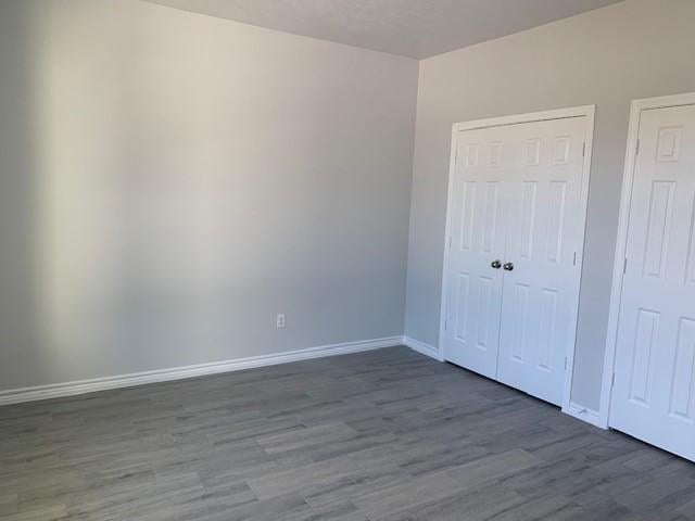 unfurnished bedroom featuring dark hardwood / wood-style floors