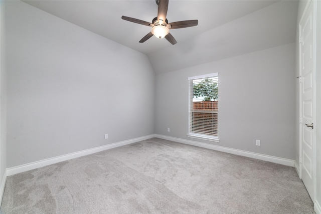 carpeted empty room with ceiling fan and lofted ceiling