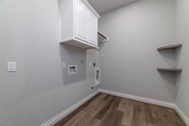 laundry room featuring gas dryer hookup, dark hardwood / wood-style floors, cabinets, hookup for a washing machine, and hookup for an electric dryer