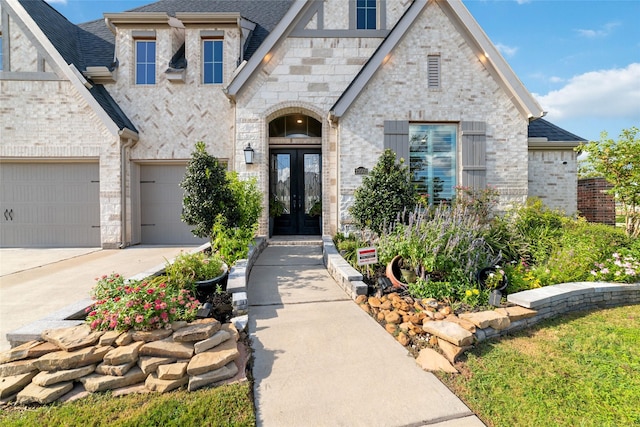 view of front of home with french doors and a garage