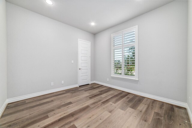 spare room featuring hardwood / wood-style floors