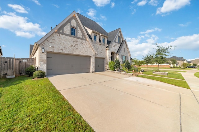 view of front of house featuring a garage and a front lawn