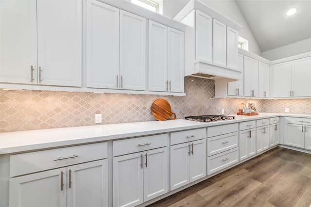 kitchen featuring white cabinetry, dark wood-type flooring, lofted ceiling, and stainless steel gas stovetop