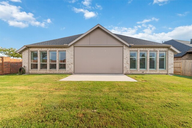 back of property featuring a patio area and a lawn