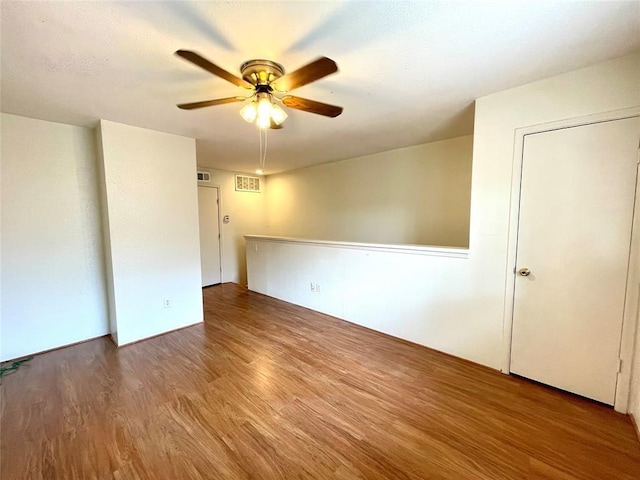 unfurnished room featuring ceiling fan and hardwood / wood-style floors