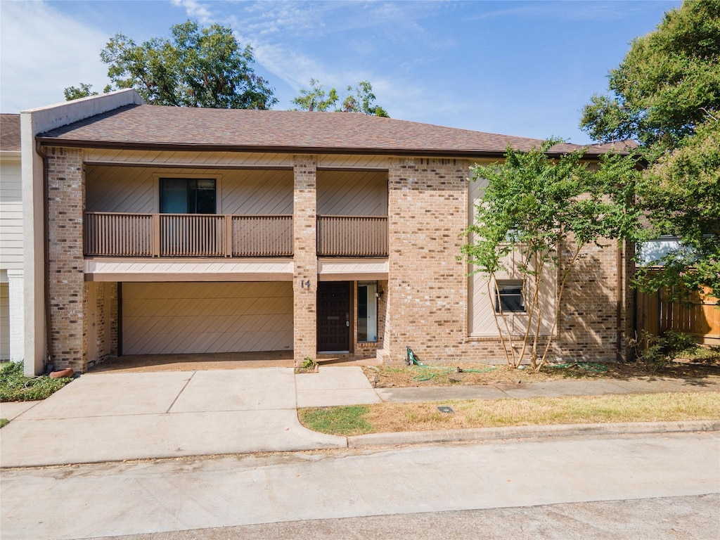 view of front of home featuring a balcony and a garage