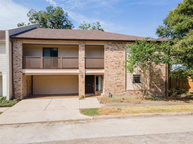 view of front of home featuring a balcony and a garage