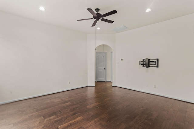 empty room with ceiling fan and dark hardwood / wood-style flooring