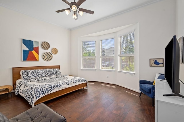 bedroom featuring ceiling fan, dark hardwood / wood-style flooring, and ornamental molding