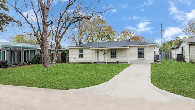 view of front of house with a front yard and central AC