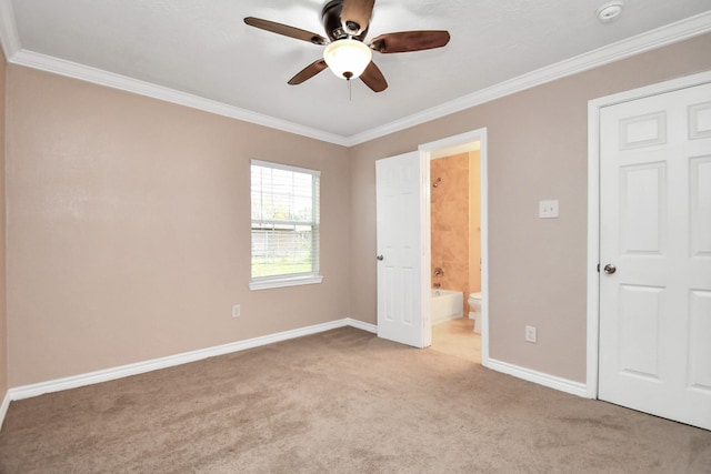 unfurnished bedroom featuring ceiling fan, light colored carpet, ornamental molding, and ensuite bathroom