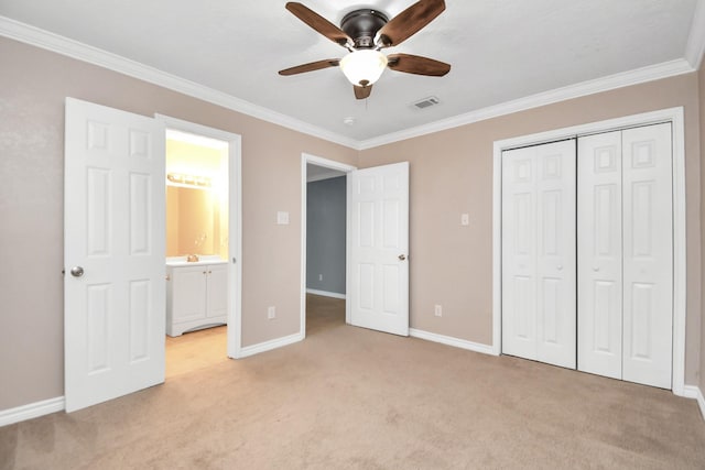 unfurnished bedroom featuring ceiling fan, a closet, light colored carpet, and crown molding