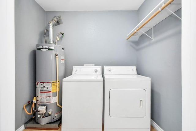 laundry room with washing machine and clothes dryer and gas water heater