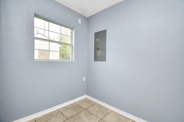 tiled empty room featuring electric panel