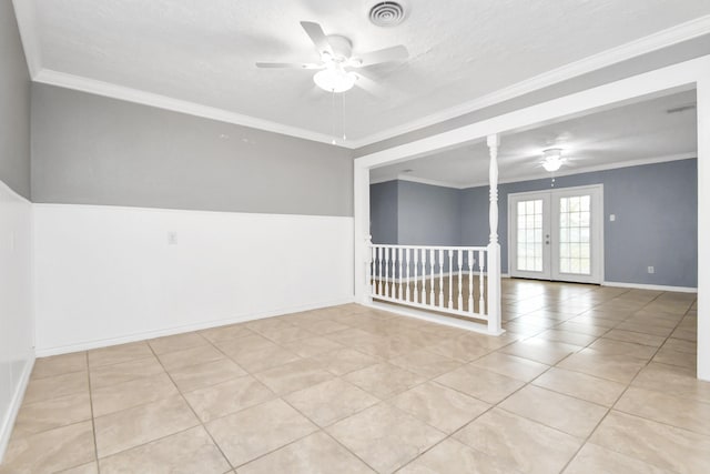 unfurnished room featuring light tile patterned floors, crown molding, and french doors