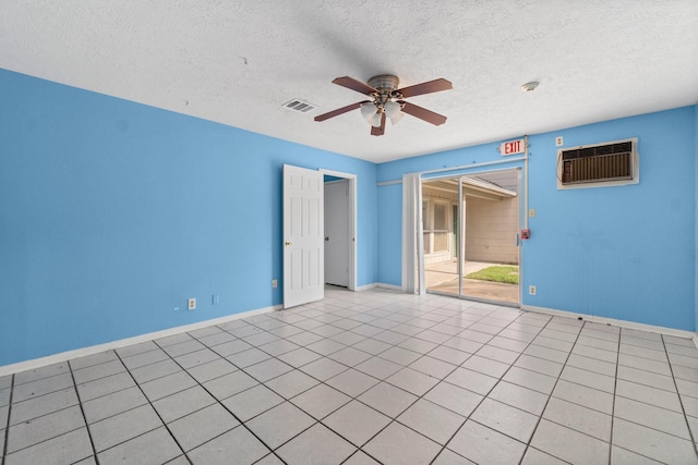 tiled spare room featuring ceiling fan and a textured ceiling