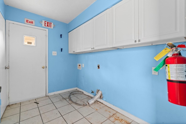 washroom featuring cabinets, hookup for a washing machine, light tile patterned floors, and hookup for an electric dryer