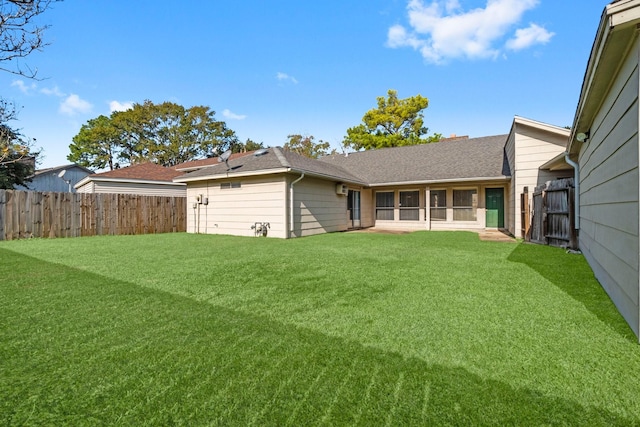 rear view of house with a yard