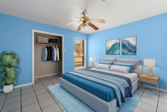 bedroom featuring ceiling fan, a closet, and light tile patterned floors