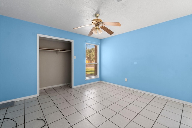 unfurnished bedroom with light tile patterned floors, a closet, and ceiling fan