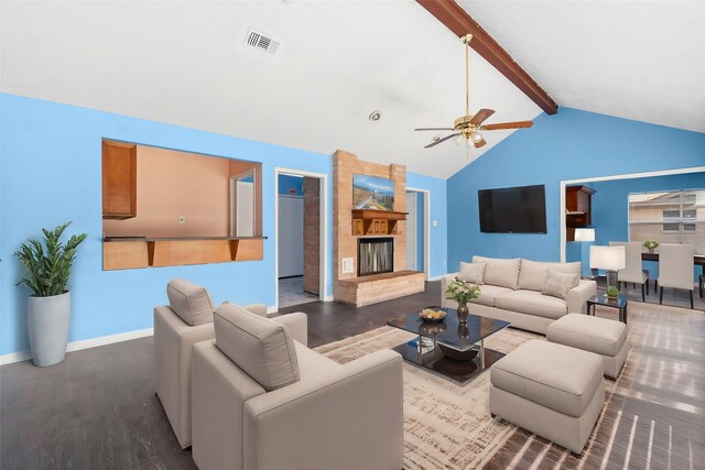 living room with vaulted ceiling with beams, ceiling fan, a fireplace, and dark hardwood / wood-style floors