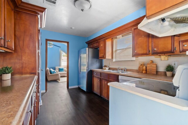 kitchen with stainless steel refrigerator, sink, range hood, and dark wood-type flooring