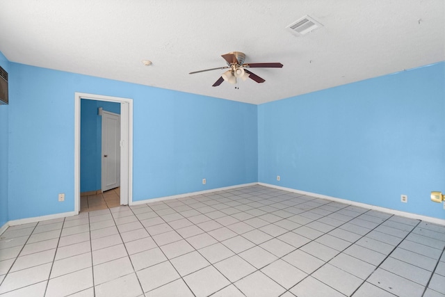 empty room with ceiling fan and light tile patterned floors