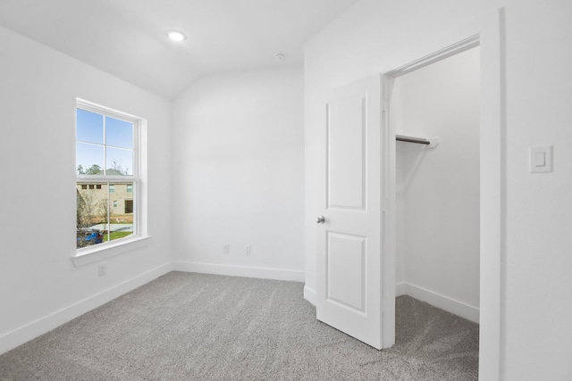 unfurnished bedroom with carpet and vaulted ceiling