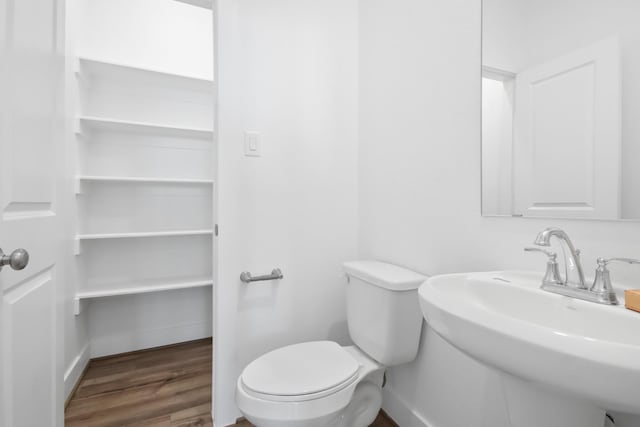 bathroom featuring sink, hardwood / wood-style floors, and toilet